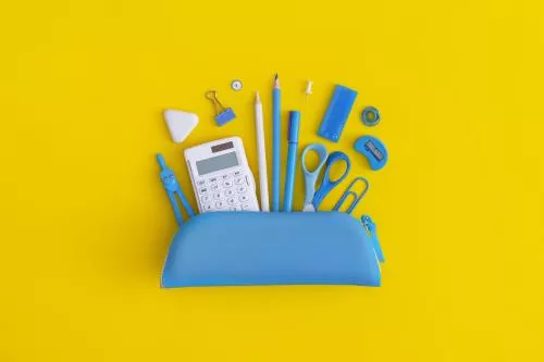 عکس رایگان JPG باکیفیتاز  جامدادی مدرسه شامل لوازم تحریر شامل قیچی و ماشین حساب و پرگار و پاکن و مداد و گیره با تم آبی با پس زمینه زرد 22134